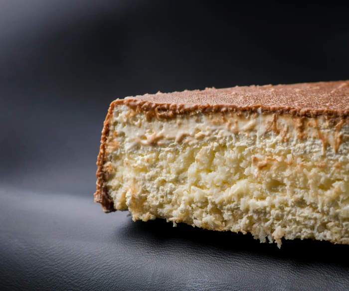 a piece of cheesecake sitting on top of a table, 3 / 4 extra - wide shot, bogna gawrońska, detailed product image, caucasian