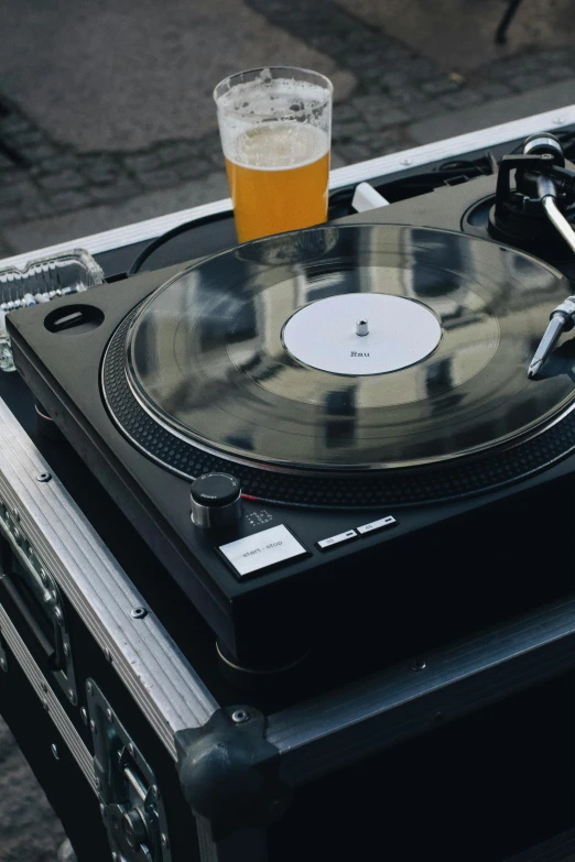 a turntable with a glass of beer on top of it, thumbnail, turntablist, diverse, penguinz0