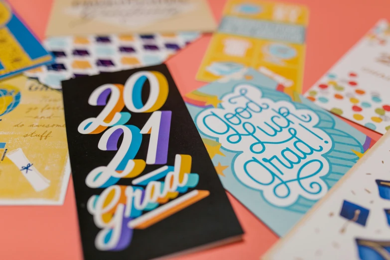 a bunch of cards sitting on top of a table, academic art, flowing lettering, colorful details, thumbnail, graduation photo