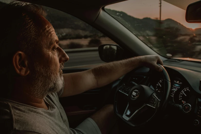 a man sitting in the driver's seat of a car, pexels contest winner, renaissance, middle aged man, profile image, last light, ad image