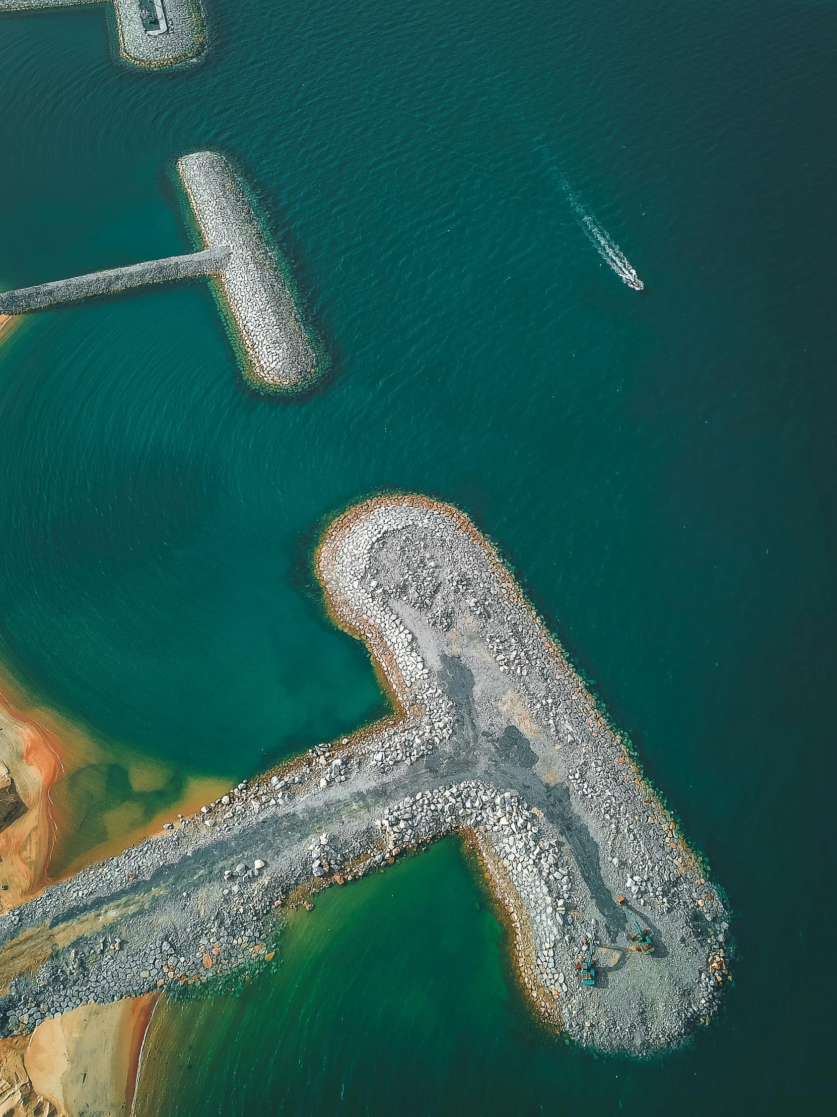 an aerial view of a large body of water, by Sebastian Spreng, unsplash contest winner, land art, harbour, thumbnail, construction, two medium sized islands