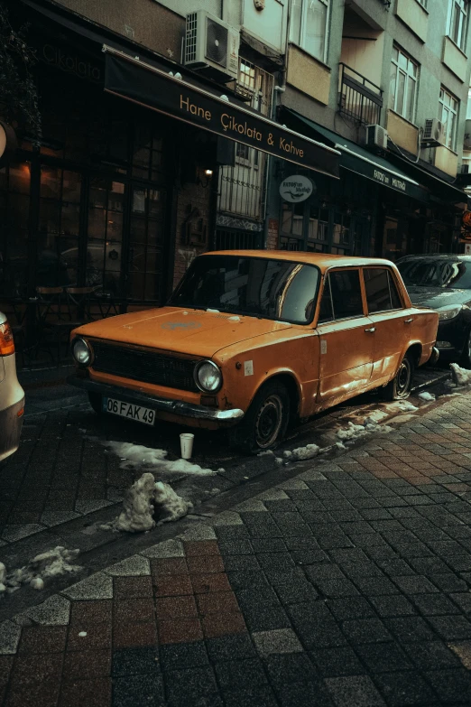 a taxi cab parked in front of a building on the sidewalk