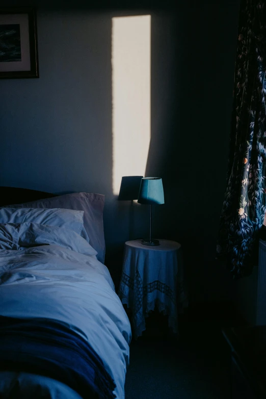 a small bedroom with sunlight streaming through a window