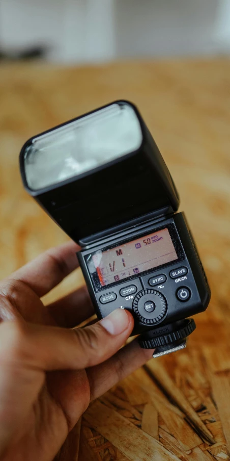 a hand holding a camera that is pointed at it