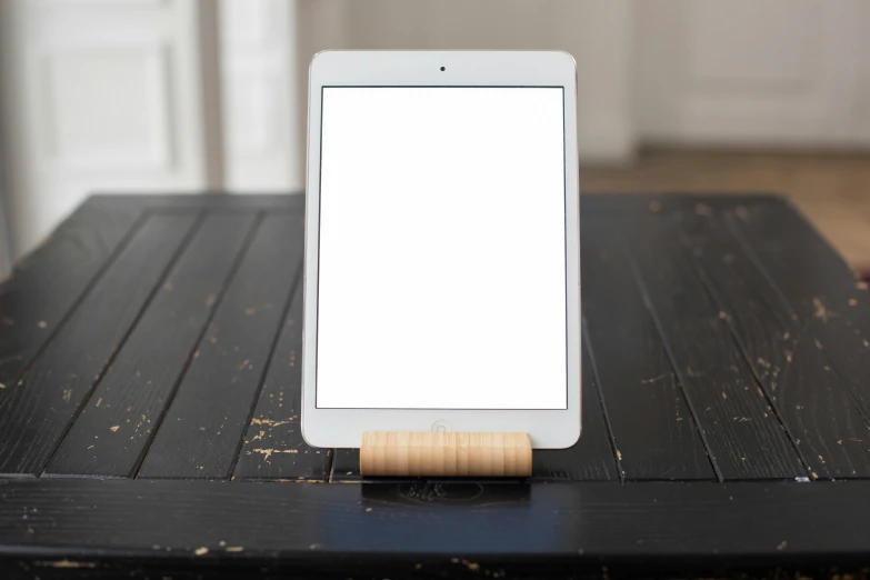 a tablet computer sitting on top of a wooden table, a portrait, by Jan Rustem, square, light wood, white light, no text