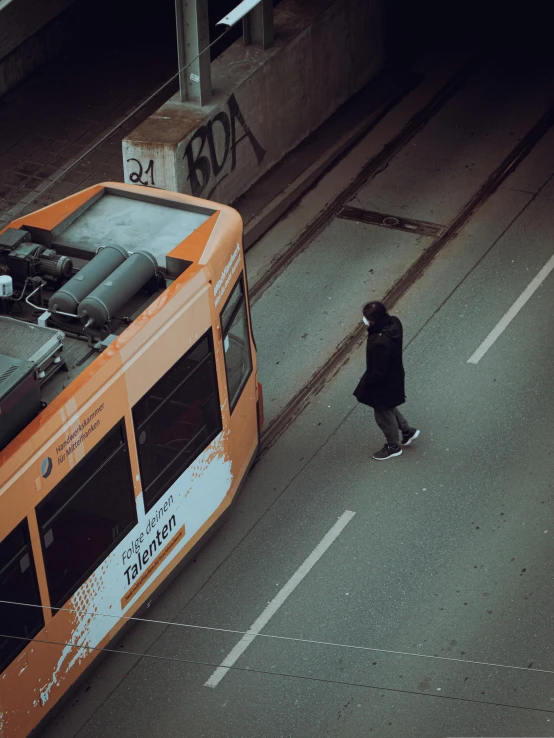 a man on the street with a bus in the background