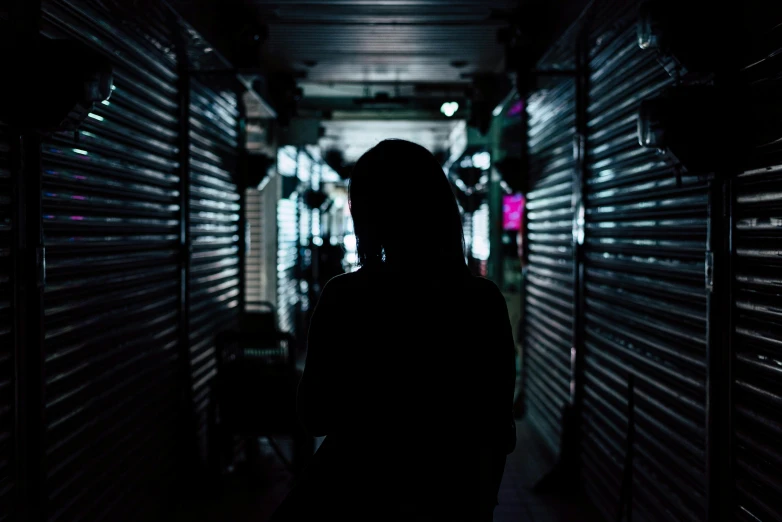 a silhouette of a person in a dark hallway, inspired by Elsa Bleda, pexels contest winner, kowloon cyberpunk, standing in a township street, standing in a server room, faceless people