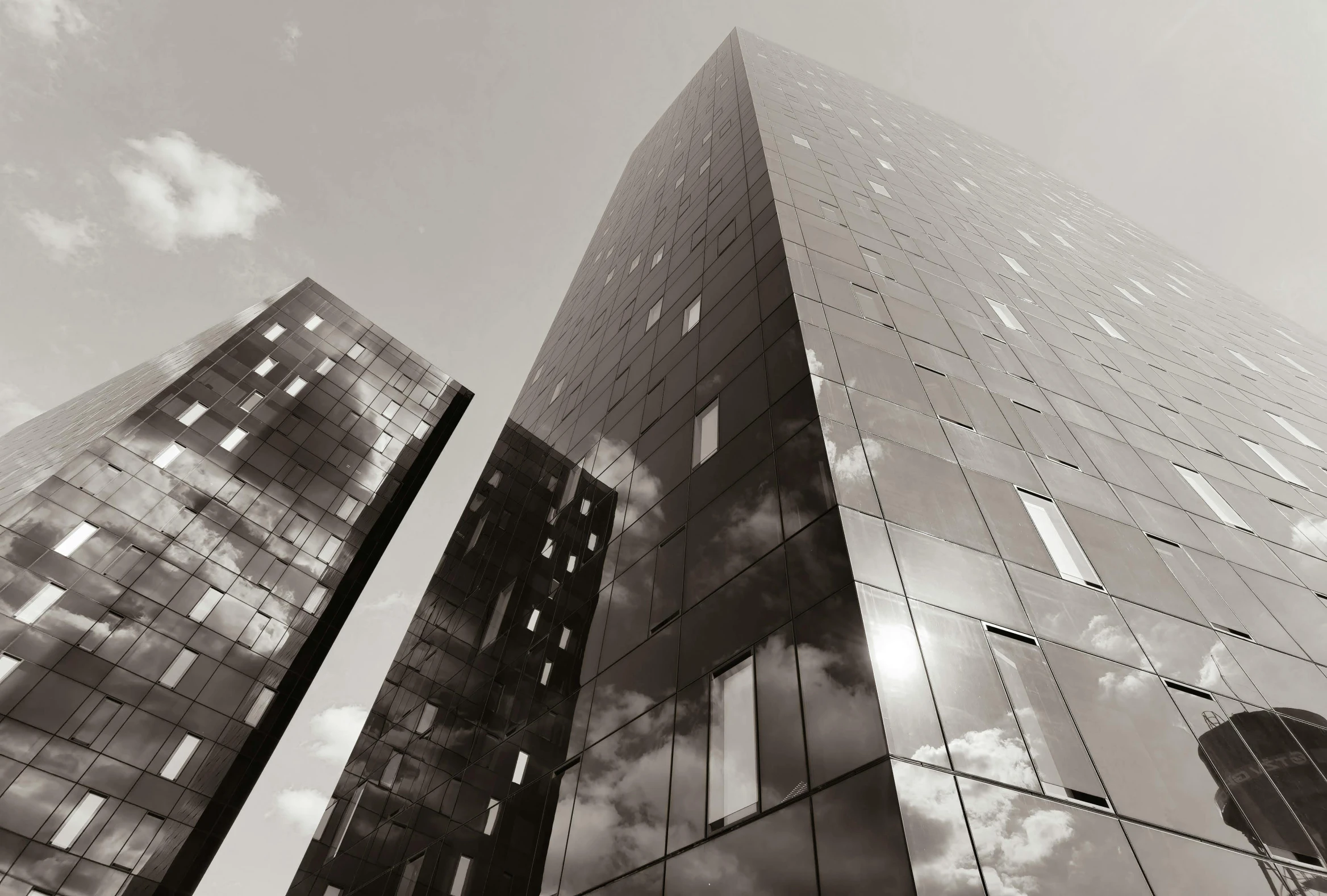 a black and white photo of some tall buildings, inspired by Richard Wilson, pexels contest winner, glass and metal : : peugot onyx, sepia, ((monolith)), minimal