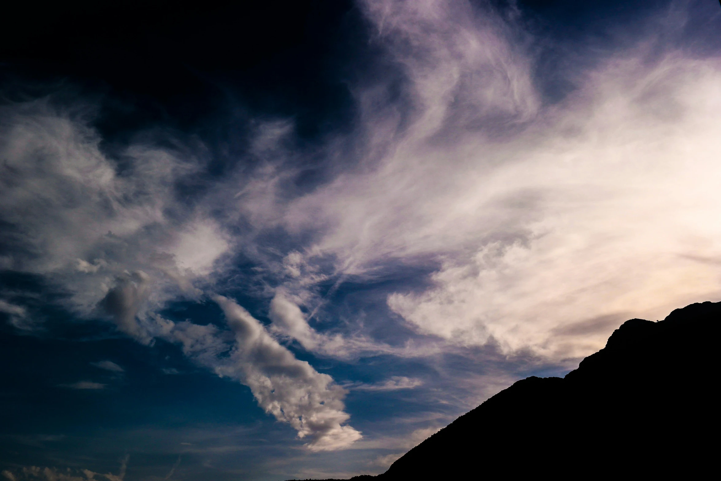 a man flying through the air while riding a snowboard, unsplash, romanticism, dark towering clouds, black volcano afar, silhouette :7, mixed art