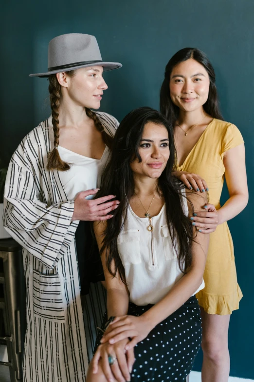 three women standing next to each other in a room, a portrait, unsplash, jamie chung, with hat, portrait n - 9, various posed