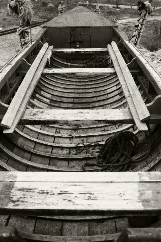 a black and white photo of a wooden boat, inspired by Edward Weston, renaissance, sectioned, ( ( photograph ) ), springs, shipyard