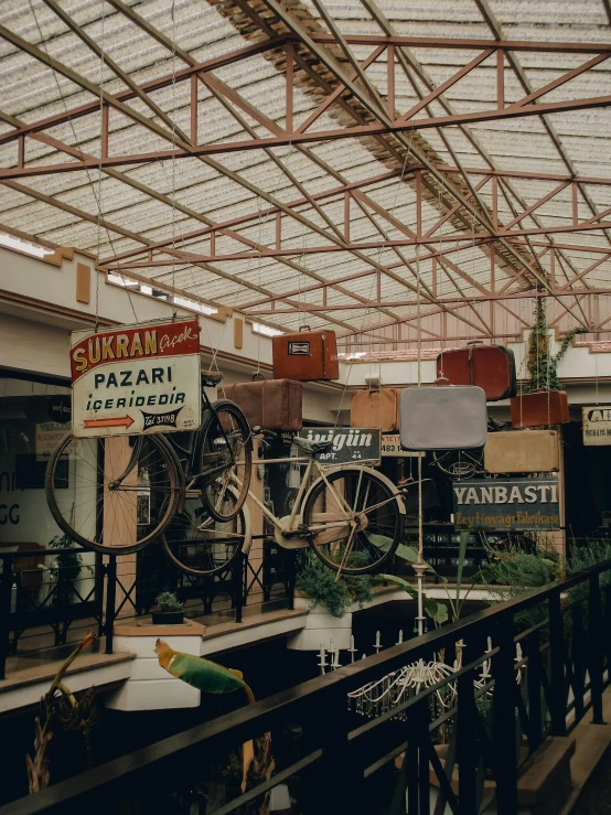 a room filled with lots of different types of bikes, pexels contest winner, art nouveau, exterior botanical garden, old signs, malls, : :