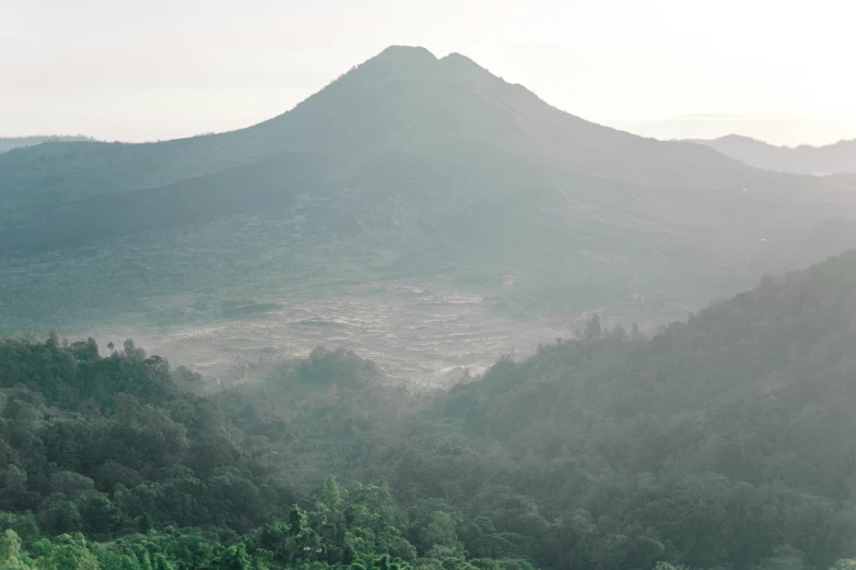 a landscape with a mountain and river