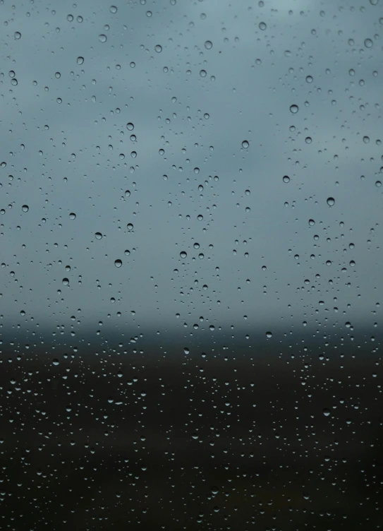 a close up of a window with raindrops on it, an album cover, unsplash, ilustration, storm on horizon, taken in the late 2010s, plain