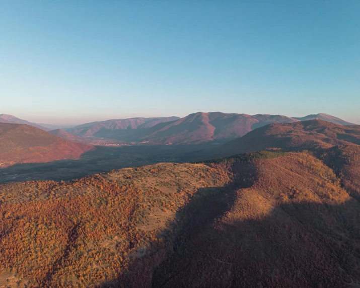 the view from the top of a mountain in autumn