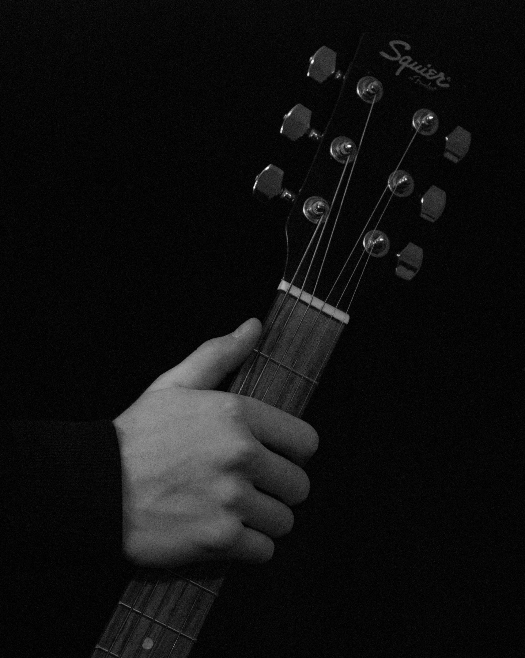 a person holding a guitar in their hands