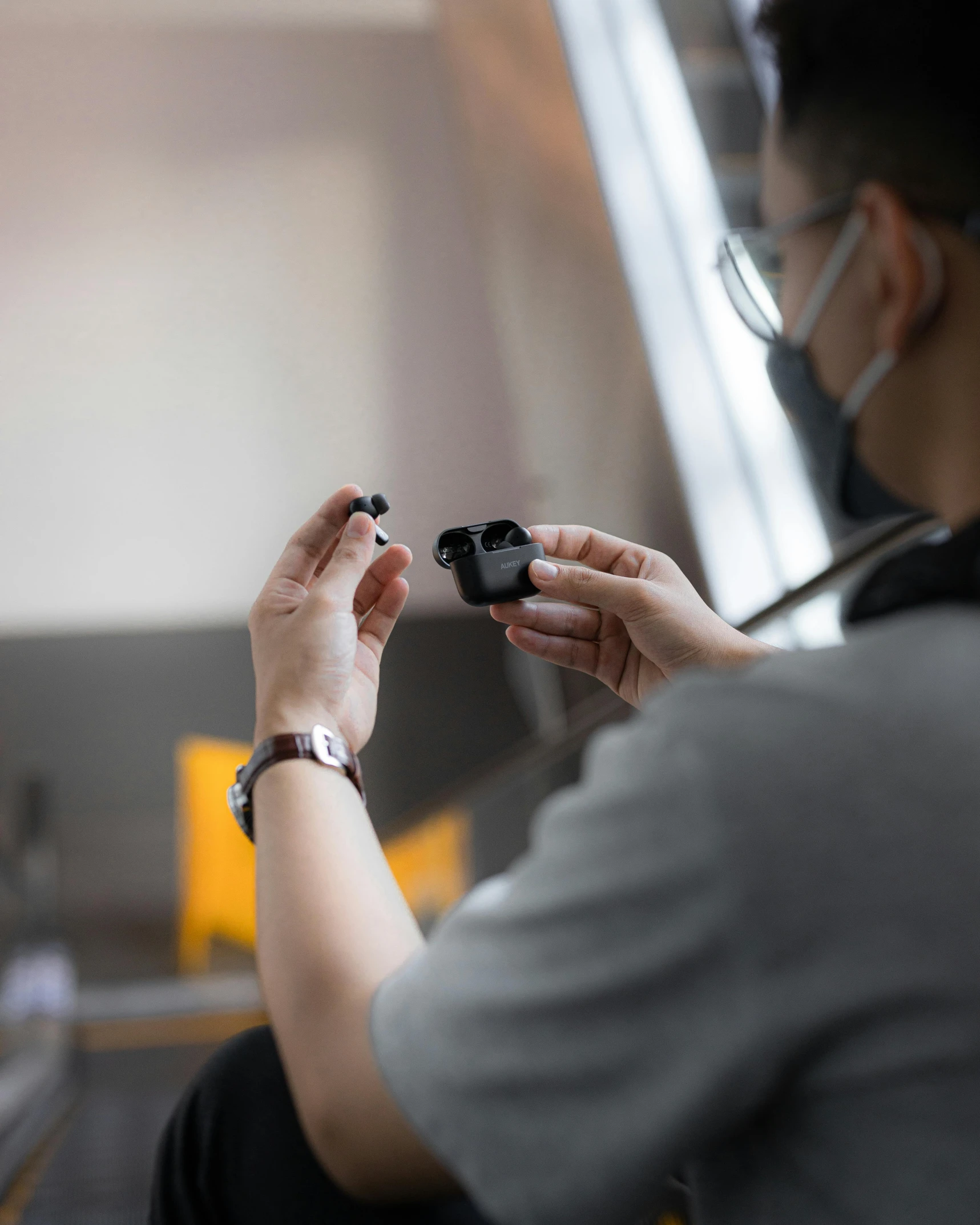 a man holding a video game controller in his hand, unsplash, microscope, worksafe. instagram photo, black resin, lgbt