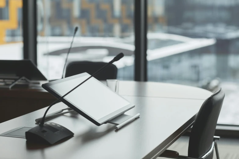 a laptop computer sitting on top of a table, a computer rendering, by Carey Morris, pexels contest winner, business meeting, table with microphones, bending down slightly, no - text no - logo