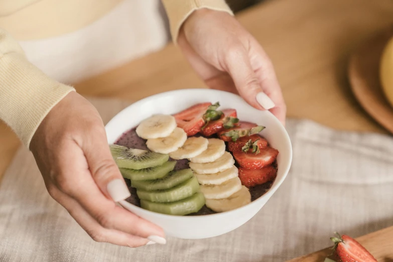 a close up of a person holding a bowl of fruit, delicious food, profile image, brown, multicoloured