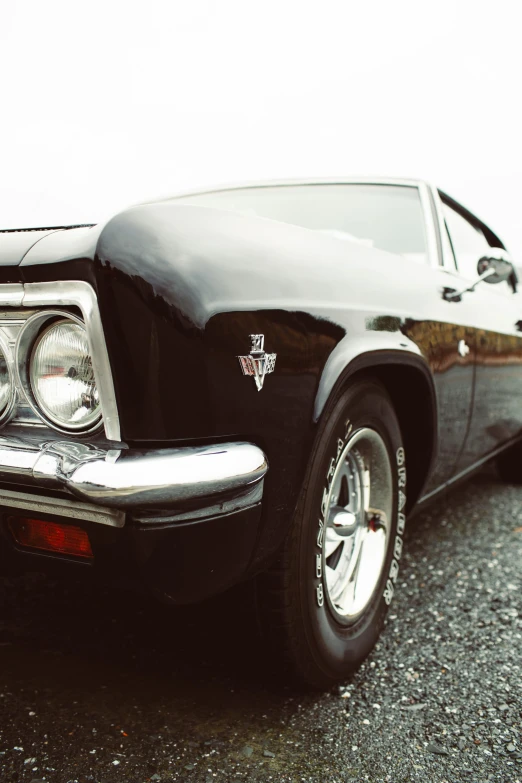 a black car parked on the side of the road, an album cover, by Tom Bonson, pexels contest winner, photorealism, muscle cars, silver crown, black, front