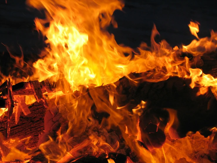 flames are seen in front of a fire log