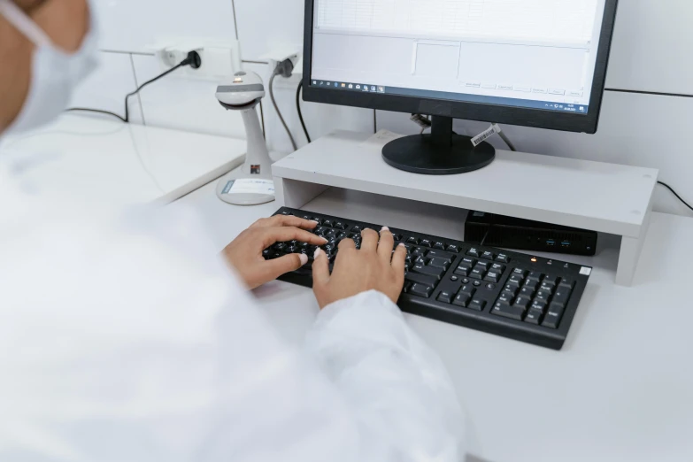 a man in a lab coat is typing on a keyboard, unsplash, avatar image