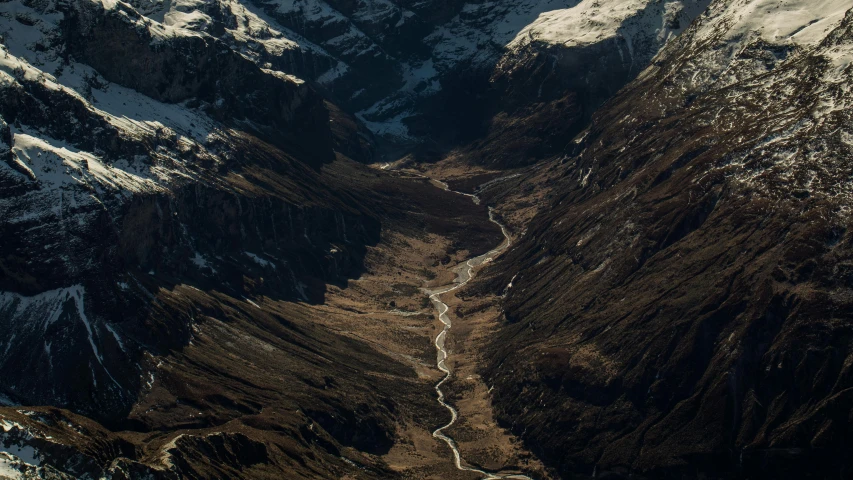 snow covered mountains are shown from above