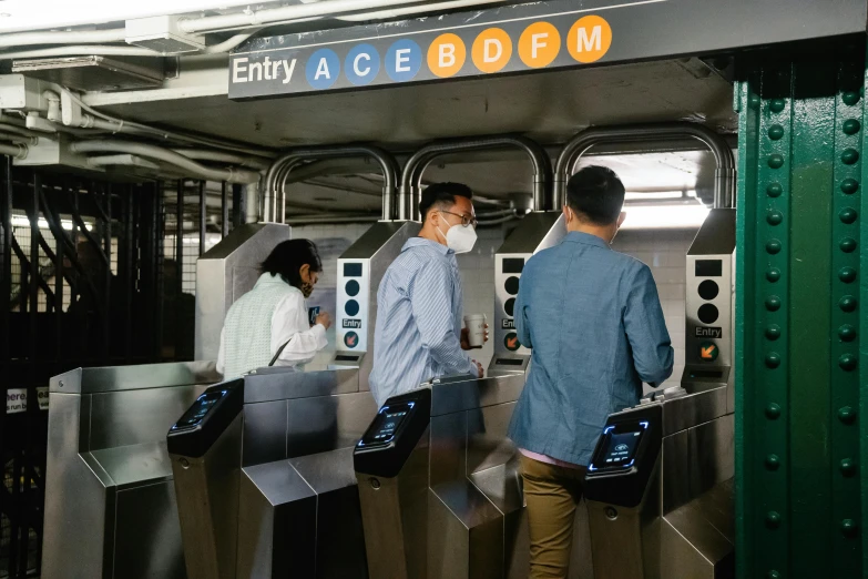 a group of people standing next to each other at a subway station, mta subway entrance, wearing facemask, avatar image, abcdefghijklmnopqrstuvwxyz