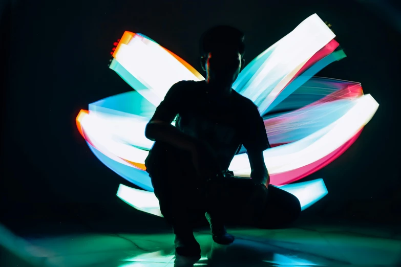 a man kneeling down in front of a light painting, pexels contest winner, interactive art, teamlab, cardistry, avatar image