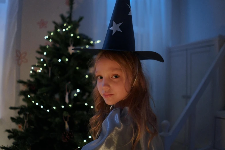 a girl wearing a wizard costume and hat