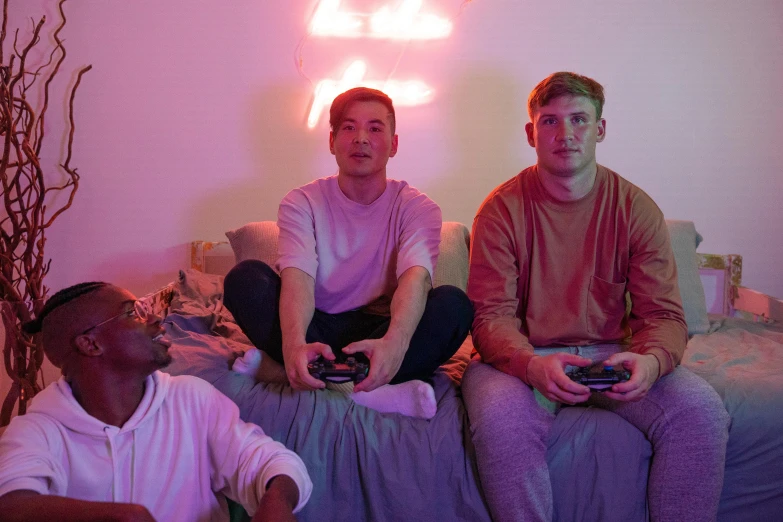 a couple of men sitting on top of a bed, an album cover, pexels, led gaming, a group of people, liam brazier, lee madgwick & liam wong