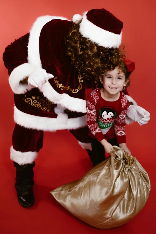 a child is smiling and holding a bag