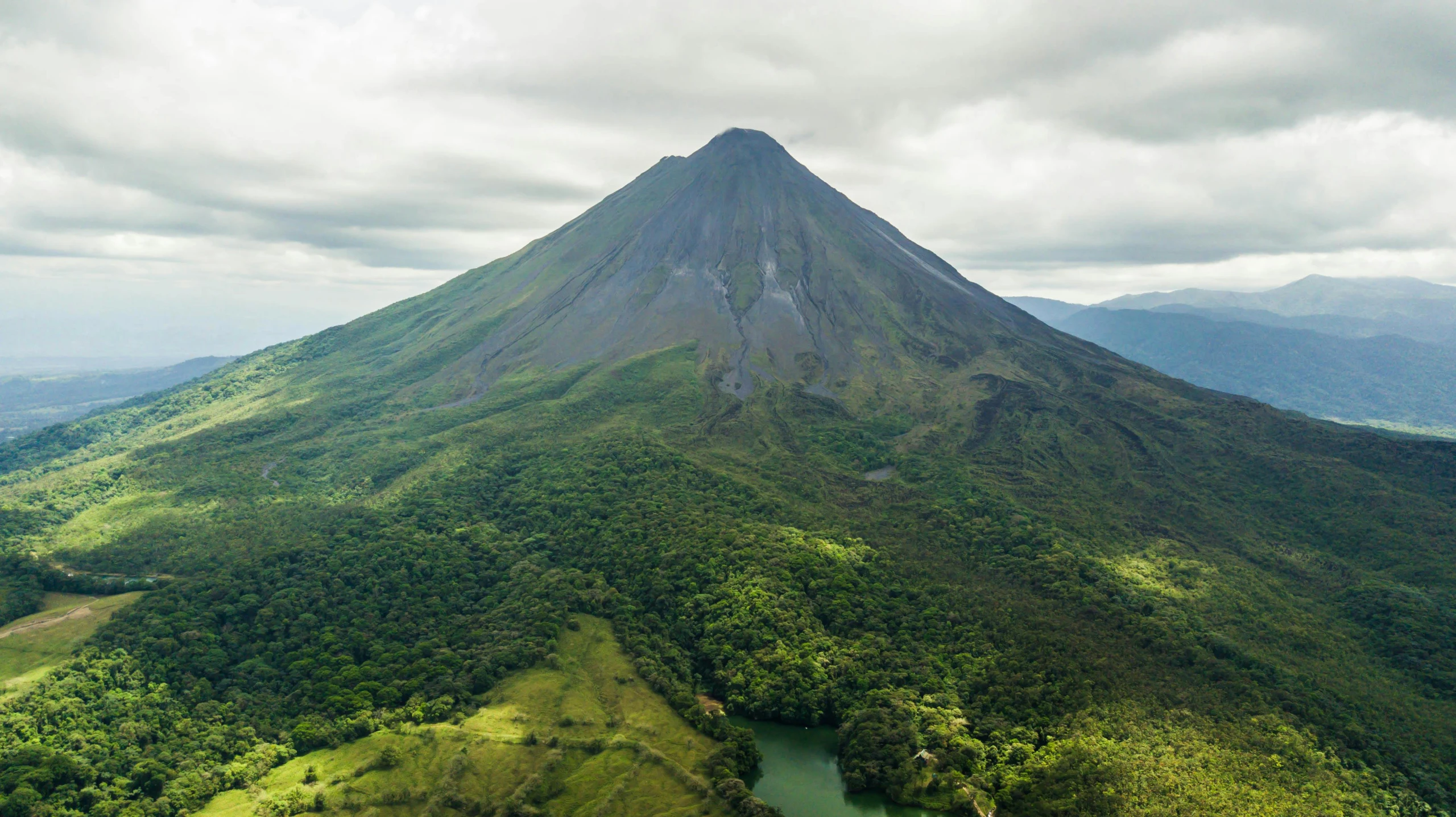 a large mountain with a lake near it