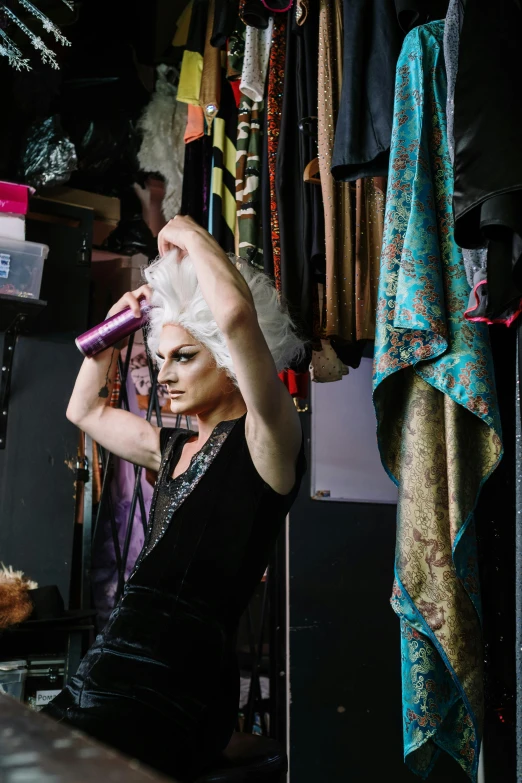 a woman is putting on her hair and posing