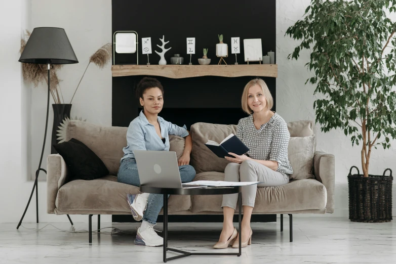 two women sitting on a couch with a laptop, by Emma Andijewska, pexels contest winner, pristine and clean design, avatar image, furniture around, studio photo