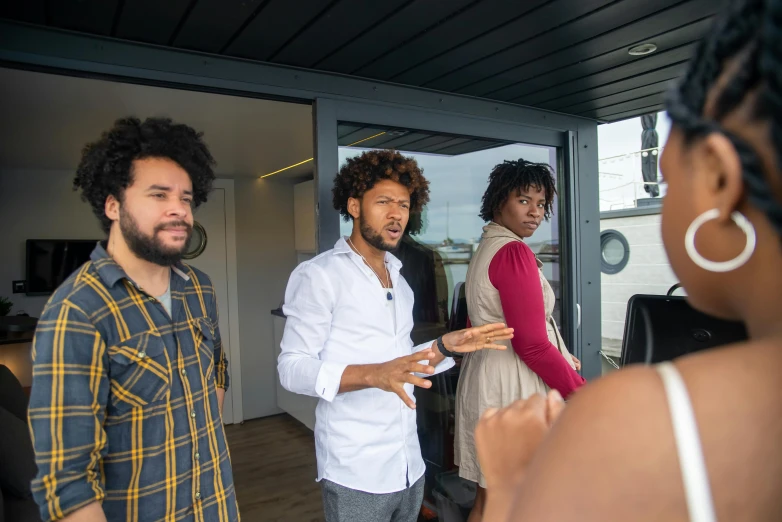 a group of people standing next to each other, pexels contest winner, black arts movement, view from a news truck, black man with afro hair, on a super yacht, teaching