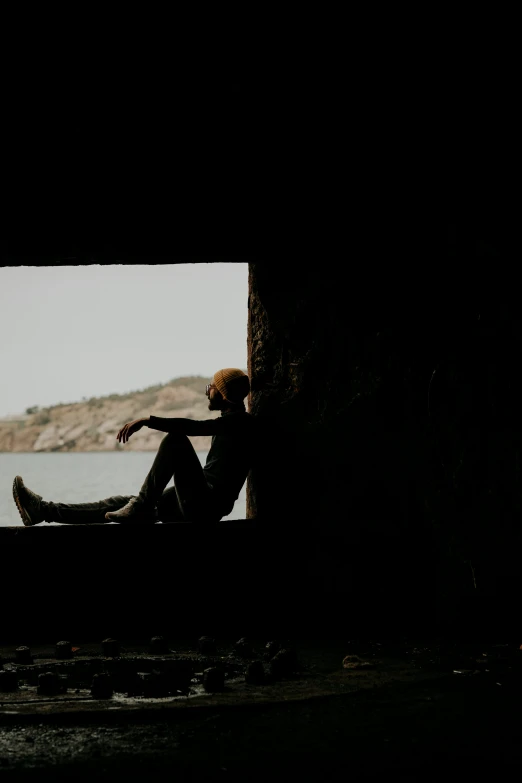 a person sitting in a boat in a dark room, overlooking the ocean, waiting behind a wall, transparent background, visuals