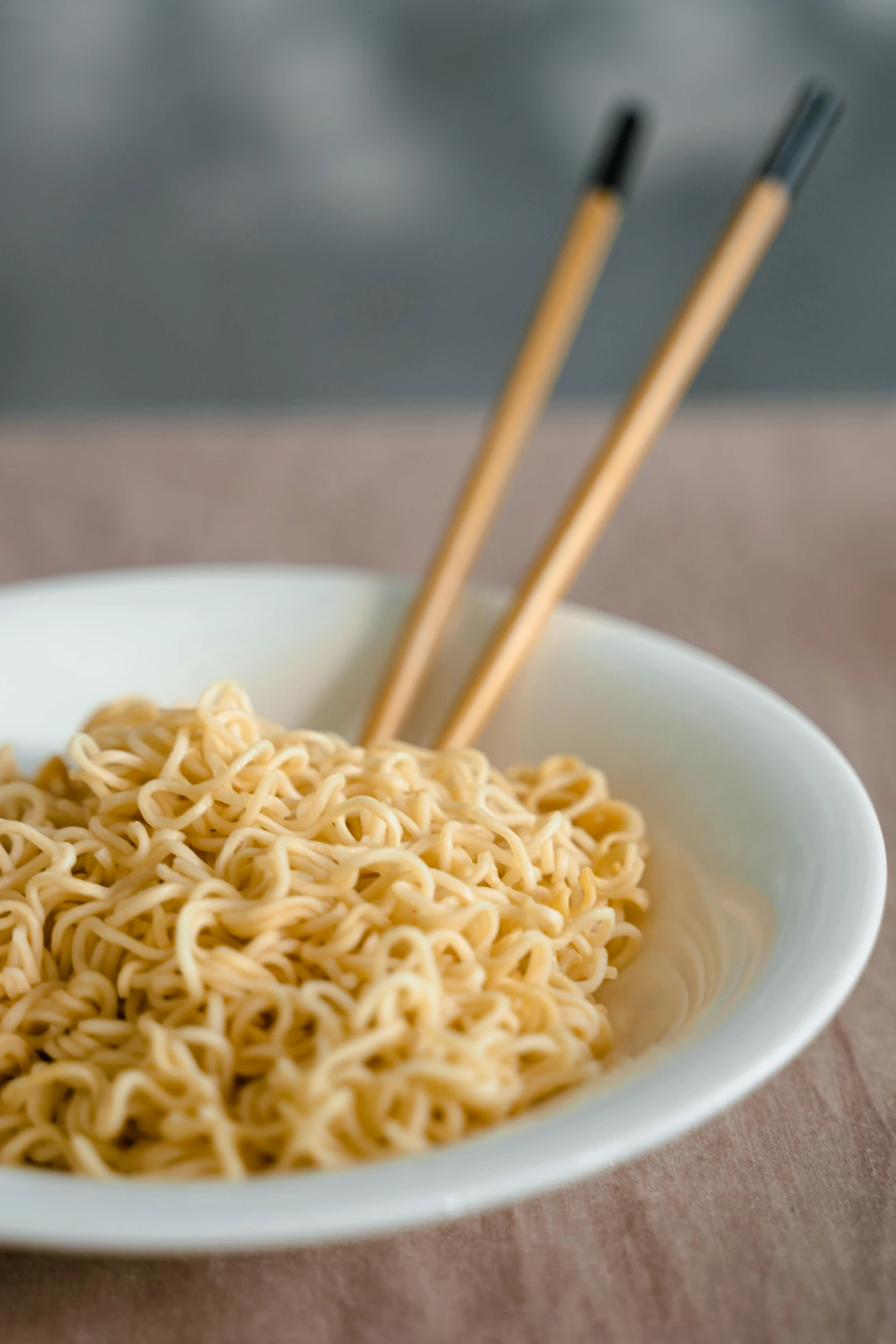 a bowl of noodles with chopsticks on a table, dau-al-set, extra crisp image, neck zoomed in, ken ishikawa, square