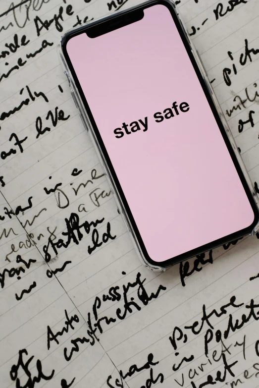 phone with stay safe text displayed in middle of writing