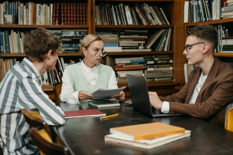 a group of people sitting around a table in a library, lachlan bailey, academicism, thumbnail, high quality image