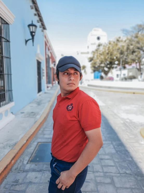 a man stands in front of a blue building