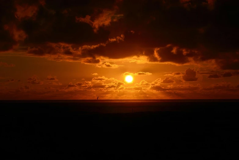 the sun is setting on the horizon of the ocean, a picture, by Jan Tengnagel, pexels, dark orange night sky, brown, infinite, sun shaft