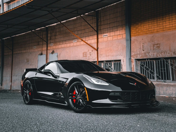 a black sports car parked in front of a building