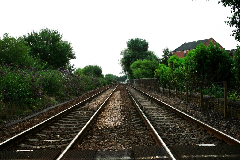 a couple of train tracks that are next to each other, an album cover, inspired by Thomas Struth, unsplash, realism, ilustration, tgv, yard, 2006 photograph