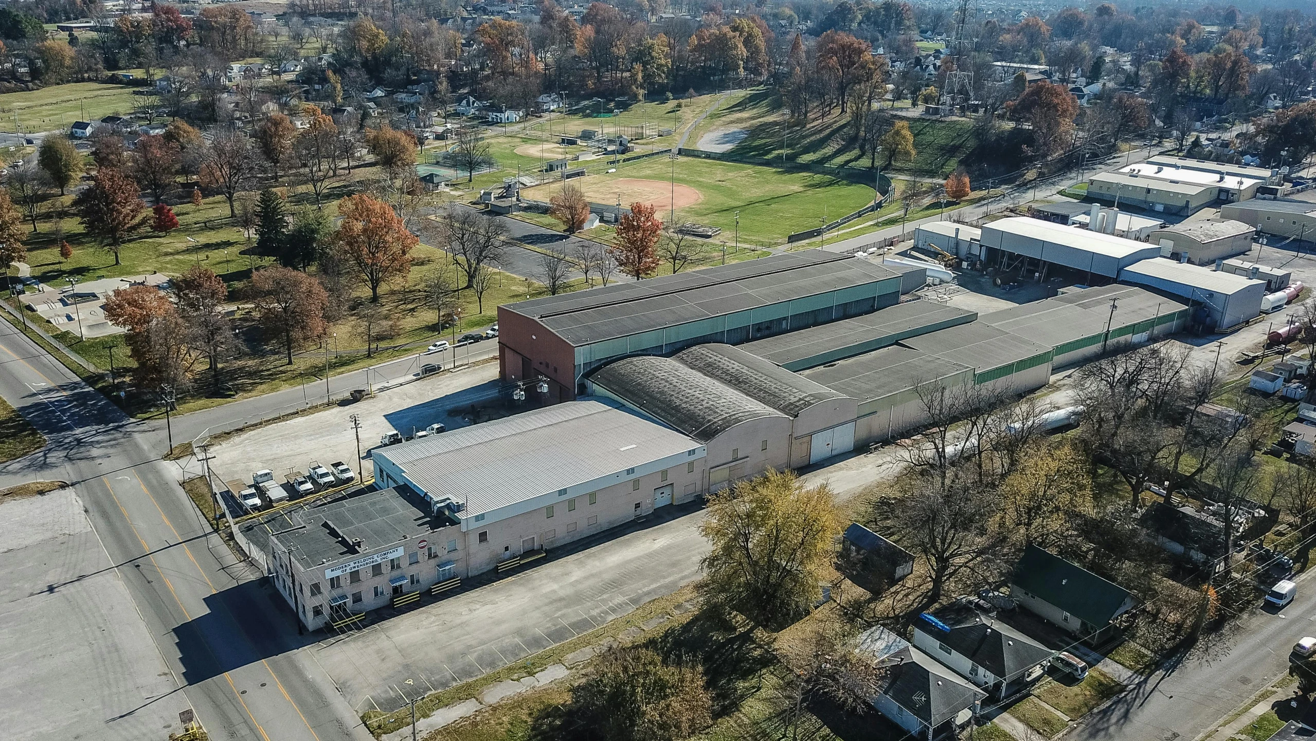 an aerial view of a large industrial building, by Dan Frazier, heidelberg school, listing image, outdoor fairgrounds, tiffany dover, preserved historical