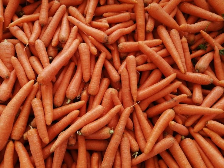 a pile of carrots sitting on top of each other, by Carey Morris, pexels, thumbnail, 1 6 x 1 6, chinese, urban surroundings