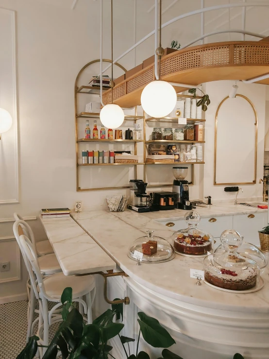 a kitchen filled with lots of counter top space, a photo, by Emma Andijewska, trending on unsplash, art nouveau, cute bakery shop, interior of a marble dome, on a white table, thumbnail