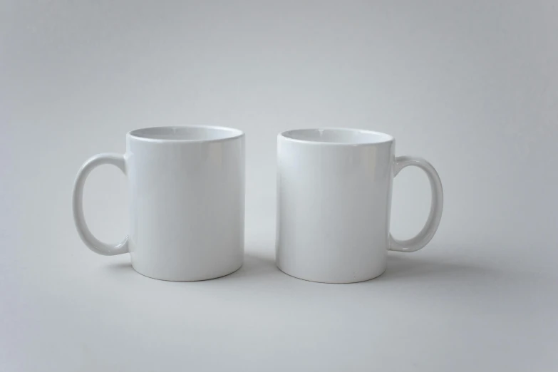 two white coffee mugs sitting next to each other, a 3D render, by Frank Mason, unsplash, photorealism, on grey background, white