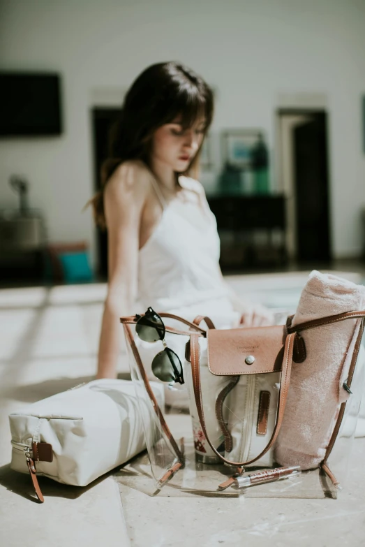 a woman looking at her handbag beside it