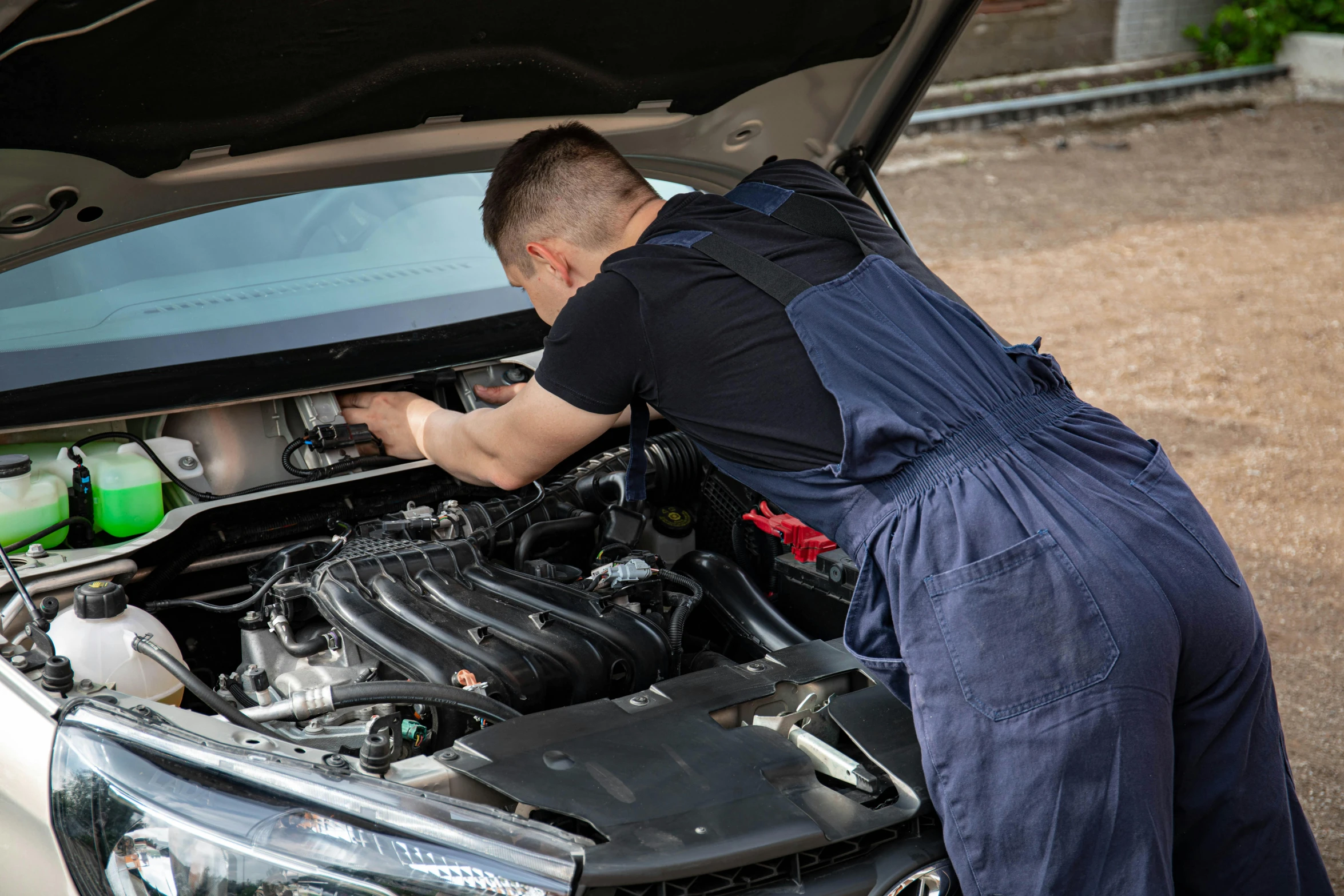 a man in overalls working on a car engine, a picture, shutterstock, 15081959 21121991 01012000 4k, lachlan bailey, 30 year old man, pristine and clean design